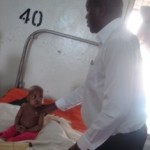 julius-prays-for-a-sick-kid-at-mwanamujimu-mulago-hospital-29th-march071-150x150